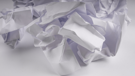 crumpled paper on white table brainstorming in the office conceptの写真素材