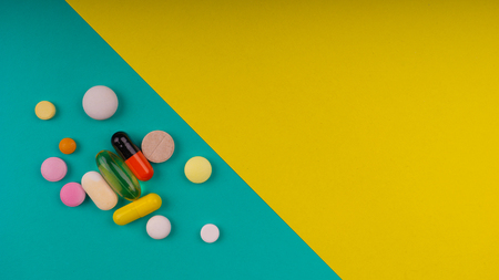 Colored pills on a bright backgroundの写真素材