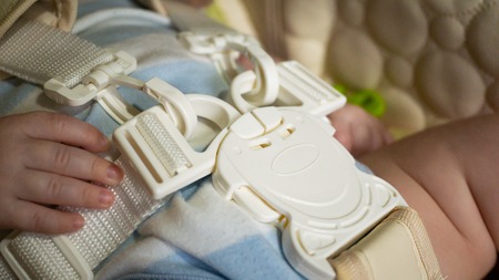 close up details of white plastic child restraint belt. five-point fixation in a child seat.の写真素材