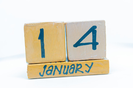 January 14th. Day 14 of month, handmade cube wooden calendar. Winter time, year conceptの写真素材
