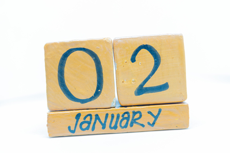 January 2nd. Day 2 of month, handmade cube wooden calendar. Winter time, year conceptの写真素材