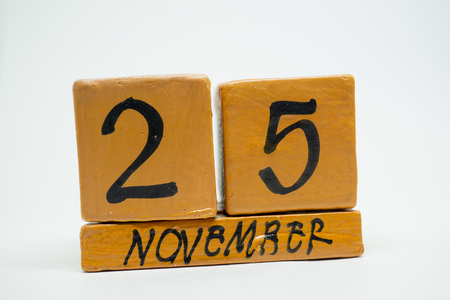november 25th. Day 25 of month, handmade wood cube calendar isolated on white background. autumn month, day of the year concept.の写真素材