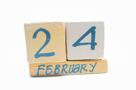 February 24th. Day 24 of month, handmade wood cube calendar isolated on white background. Winter month, day of the year conceptの写真素材