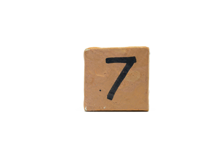 Number seven on cube of wooden material isolated on whiteの写真素材