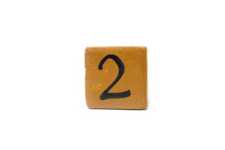 Number two on cube of wooden material isolated on whiteの写真素材