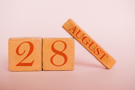 august 28th. Day 28 of month, handmade wood cube calendar  on modern color background. summer month, day of the year concept,.の写真素材