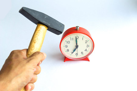 Hammer Hitting Alarm clock , isolated on white