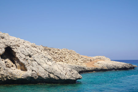 view of a small rock protruding into the sea on a Sunny day. Rest at sea, tourism, holidays....