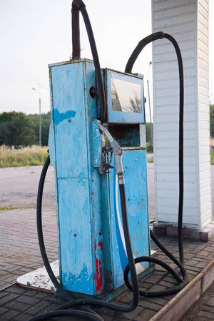 Old abandoned fuel station, gas station on secondary provincial road, fuel dispenser is broken. vintage gasoline column. Oil pollution of the earth. Outdated technology.の写真素材
