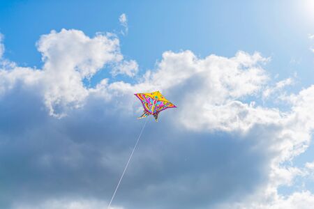Beautiful colorful butterfly kite against the sky and clouds, freedom vacation travel concept.の写真素材