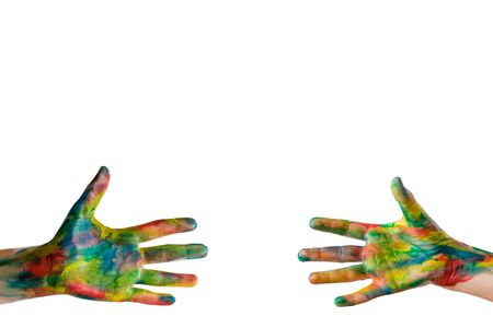 Reaching a hand. Close-up of human hands painted in bright colors trying to reach each other isolated on white. Clipping path included.の写真素材