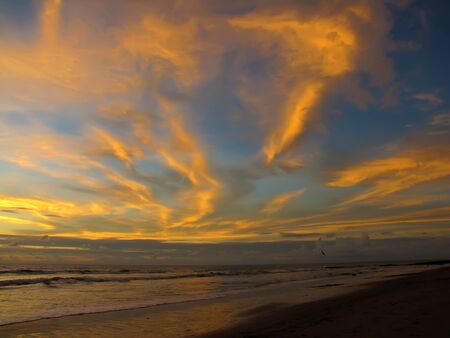 beautiful red sunset over the ocean. Bright sunset with large yellow sun under the sea surface. sundown seascape.の写真素材