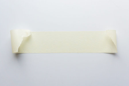white adhesive tape on white background. close up shot. top view.