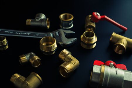 Plumbing equipment on a black background. Valves and wrenchの写真素材