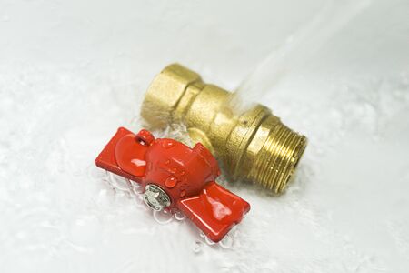 sanitary ball valve under the water flow. close up. Plumbing equipment.の写真素材