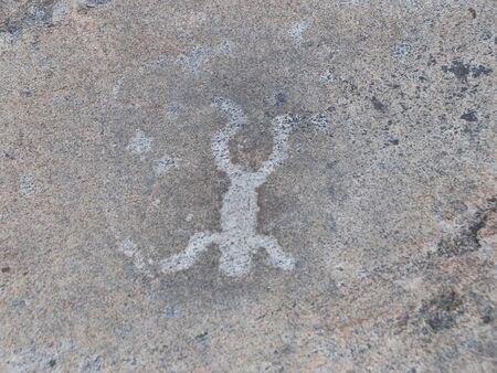 Petroglyph Primitive drawings on stones. Ancient art by prehistoric humans.の写真素材