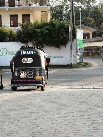 Traditional transport in Asia. Taxi TUK TUK waits for passengers in a parking lot in Mirissa, Sri Lanka. Mirissa, Sri Lanka, February 25, 2020のeditorial素材