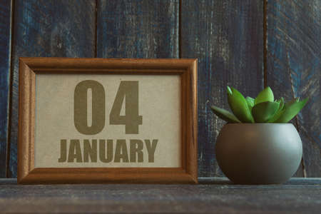 january 4th. Day 4 of month, date in frame next to succulent on wooden background winter month, day of the year conceptの写真素材