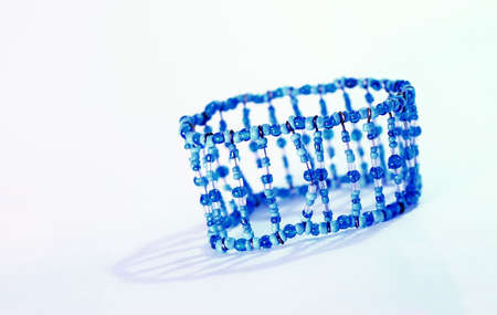 Bracelet with blue plastic beads on white background.の写真素材