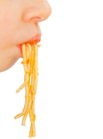 Face of little boy pulls spaghettiの写真素材