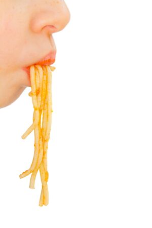 Face of little boy pulls spaghettiの写真素材