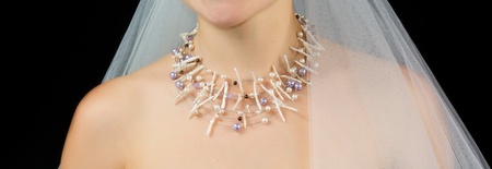 Jewelry on the neck of bride . Studio shot with black background.の写真素材