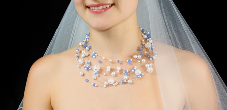 Jewelry on the neck of bride . Studio shot with black background.の写真素材