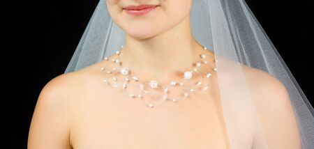 Jewelry on the neck of bride . Studio shot with black background.の写真素材