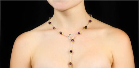 Jewelry on the neck of women . Studio shot with black background.の写真素材
