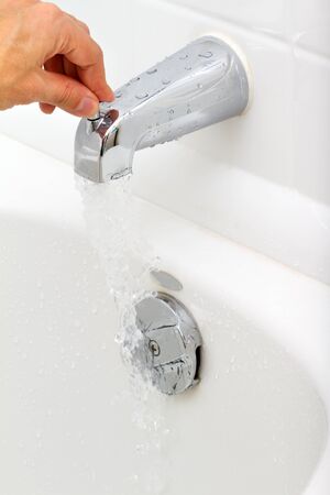 Demonstration of how the water tap is working in a bathroomの写真素材