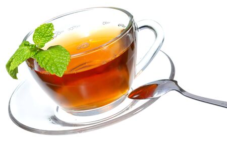 Tea cup with mint leaves on a white backgroundの写真素材