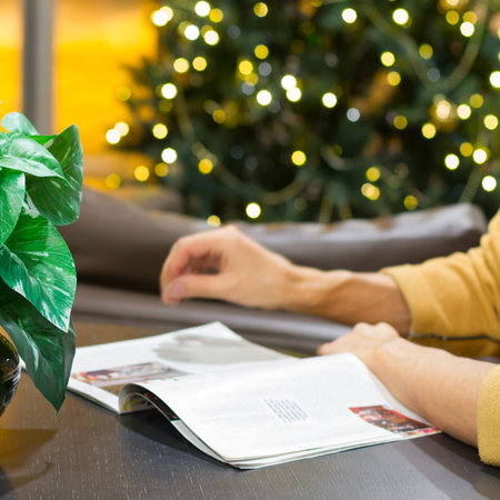 Man reading a magazine at Christmas