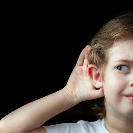 Boy Trying to hear somethingの写真素材