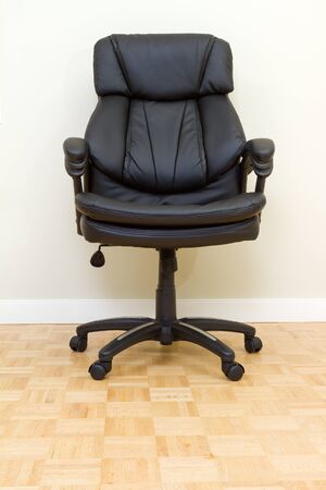 Black Leather chairman chair in officeの写真素材