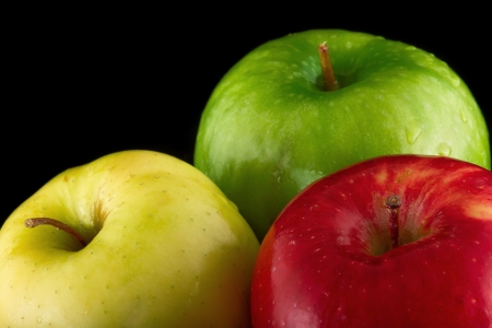 Red, Yellow and Green Apple on a black backgroundの写真素材