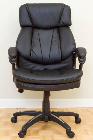 Black Leather chairman chair in officeの写真素材