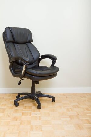 Black Leather chairman chair in officeの写真素材