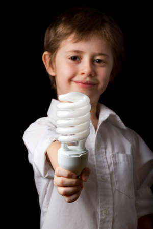 Boy holding a energy saving lampの写真素材