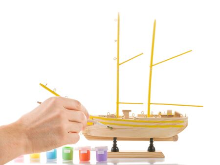Man paints model sailing shipの写真素材