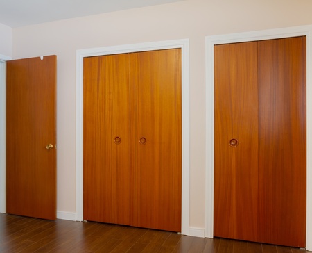 Wooden doors of the closets in the bedroomの写真素材