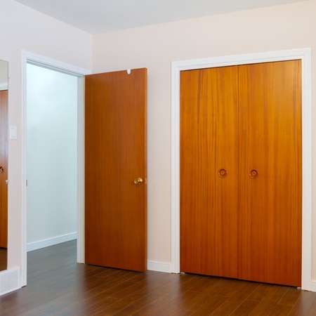 Wooden doors of the closets in the bedroomの写真素材