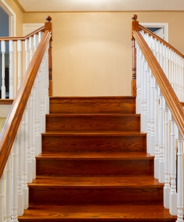 Beautiful foyer looking down hardwood stairs in new houseの写真素材