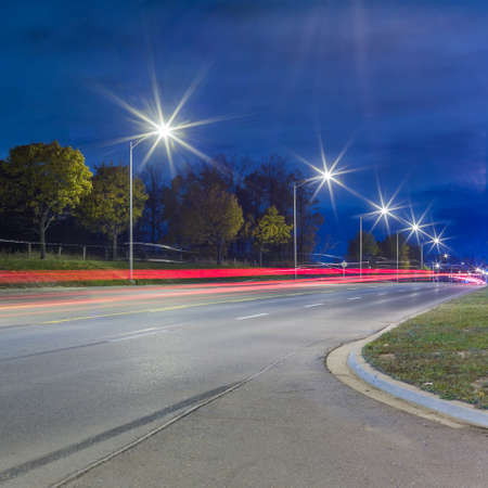 Road traffic and light trails at nightの写真素材