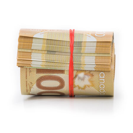 Roll of Canadian banknotes wraped with a rubber bandの写真素材