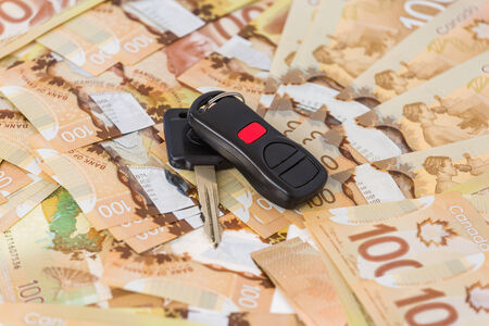 Keys from car on banknotesの写真素材