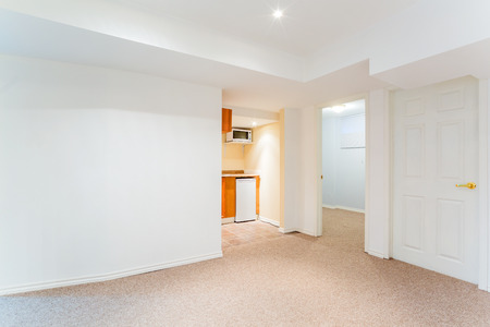 Empty basement living room with kitchen designの写真素材