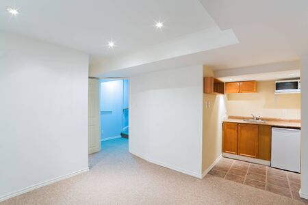 Empty basement living room with kitchen designの写真素材