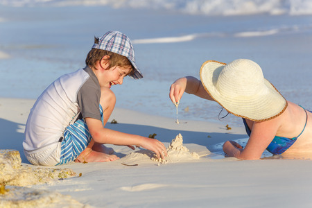 Family making sand castle at the beachの写真素材