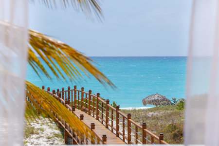 Sea view through white curtains at the beachの写真素材