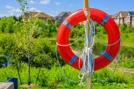 Lifebuoy on a background of luxury houses in the suburbs of Torontoの写真素材